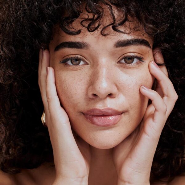 Beauty, portrait and natural face of black woman with healthy freckle skin texture touch. Aesthetic, facial and skincare cosmetic model girl touching cheeks for self love and wellness. Beauty, portrait and natural face of black woman with healthy freckle skin texture touch. Aesthetic, facial and skincare cosmetic model girl touching cheeks for self love and wellness